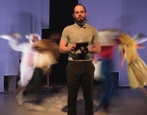 Homme au centre regardant le public. Personnes en rond derrière tournant à toute vitesse.